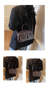 Detailed view of dark brown leather pillow bag featuring white woven stitching and pockets