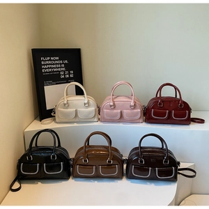Multiple colors of Boston handbags with distinctive white contrast stitching details