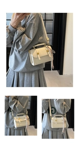 Close-up of cream square handbag featuring gold hardware and striped silk scarf wrap