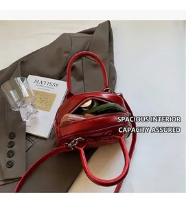 Interior view of red glossy oil-wax leather handbag showing spacious storage capacity