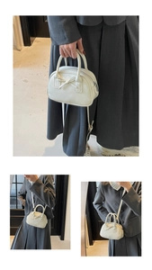 Detailed macro view of the cream white bowling bag featuring a 3D ribbon bow and matte PU leather