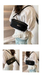 Detailed close-up of a black leather baguette bag featuring a silver metal twist lock