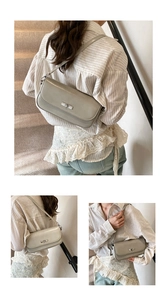 Detail view of a chic grey baguette bag with silver twist lock and slim shoulder strap