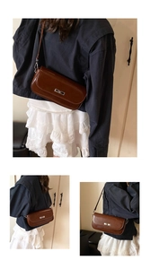 Detail showing the glossy brown leather texture and silver buckle of the baguette bag