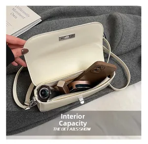 Interior view of white baguette bag showing storage for phone, lipstick, and perfume