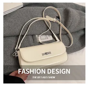 Detailed close-up of a cream PU leather bag with silver metallic twist-lock closure
