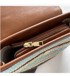Detailed shot of smooth golden metal zipper and colorful striped woven fabric on beach bag