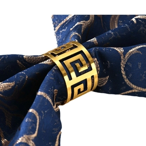 Golden Greek meander hollow napkin ring on blue patterned silk with glossy metallic finish