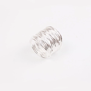 Detailed close-up of handmade multi-layer silver wire napkin ring with minimalist texture