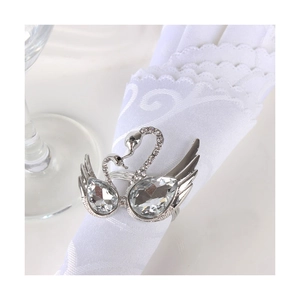 Elegant silver swan napkin ring with sparkling crystals on white lace napkin
