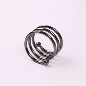 Macro view of gunmetal spiral napkin ring featuring three coils and polished double beads