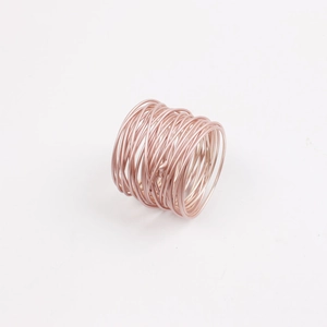 Detail shot of multi-layered wire wrap napkin ring in polished rose gold finish