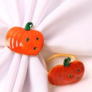 Detail view of orange pumpkin napkin rings with gold finish for autumn table decor