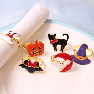 Detail of 6-piece Halloween napkin rings with ghost and pumpkin charms on a plate