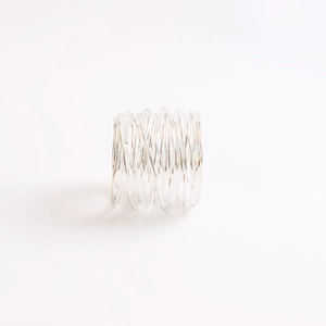 Detailed view of layered silver wire-wrapped napkin ring with minimalist metal texture