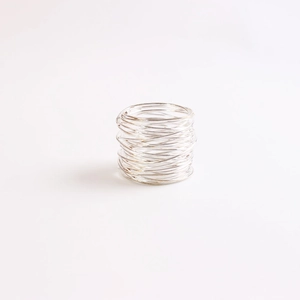 Close-up of silver wire napkin ring with minimalist handcrafted multilayered design