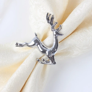 Silver reindeer napkin ring on white fabric napkin for Christmas table decoration