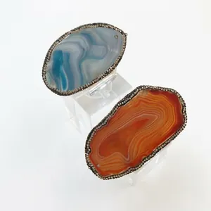 Natural agate napkin rings with irregular textures and sparkling crystal borders in blue and orange