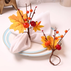 Fall napkin rings with orange pumpkins and maple leaves on a white dining table set