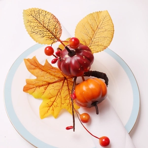 Detailed view of autumn pumpkin napkin ring with maple leaves and berries on white plate