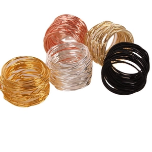 Set of five wire wrapped metal napkin rings in gold, silver, rose gold and black colors