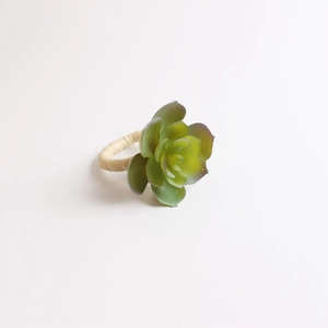 Detailed close-up of realistic faux succulent napkin ring with rustic straw-woven band