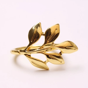 Close-up of matte gold leaf napkin ring showcasing detailed veins and polished finish