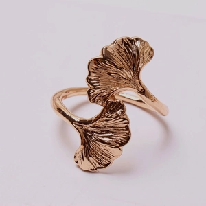Macro detail of rose gold ginkgo leaf napkin ring with clear textured metal veins