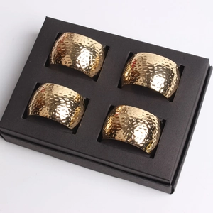 Set of 4 gold hammered metal napkin rings in premium black gift box packaging