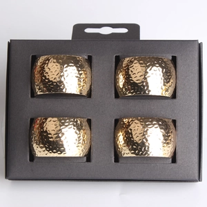 Set of 4 gold hammered metal napkin rings in a black retail presentation box