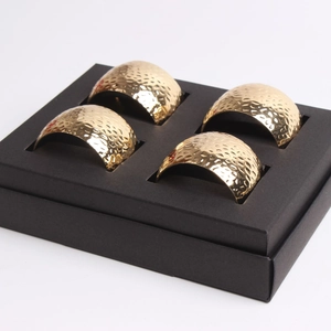 Set of 4 gold hammered metal napkin rings in a premium black gift box presentation