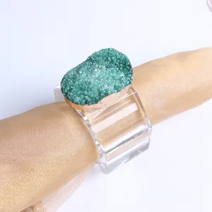 Close-up of agate crystal napkin ring with gold edges on a luxury square acrylic base
