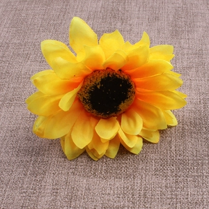 Detailed macro view of artificial sunflower napkin ring with yellow fabric petals