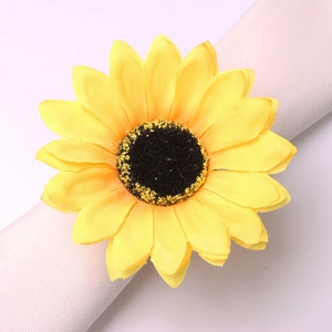 Macro shot of realistic sunflower napkin ring with yellow fabric petals and golden base