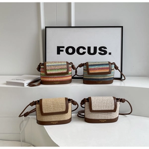 Detail of four woven straw crossbody bags with leather bases in various stripe patterns