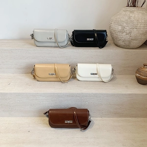 Elegant vintage flap crossbody bags in five colors on a stone step display