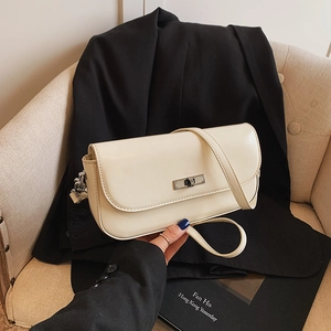 Chic beige baguette bag with silver metallic turn-lock and adjustable shoulder strap