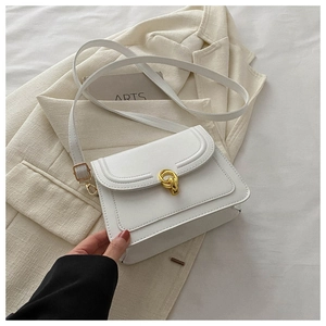 Close-up of white leather flap bag with gold interlocking buckle and matte finish