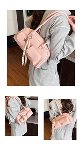 Detailed view of pink leather shoulder bag with double pockets and star pendant