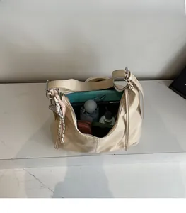 Top view of large capacity beige tote bag showing spacious interior with personal items