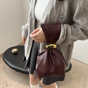 Retro burgundy pleated leather handbag with gold metal accents and minimalist design