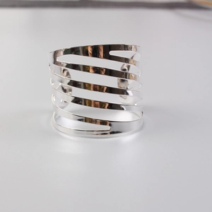 Detail of silver striped napkin ring featuring a modern multi-layer spiral hollow design