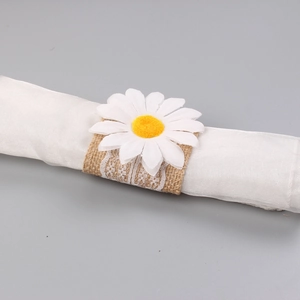 Close-up of rustic daisy flower napkin ring with natural jute and white lace details