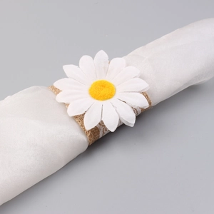 Close-up of daisy napkin ring featuring white fabric petals and burlap lace holder