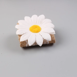 Detailed view of rustic burlap napkin ring with white daisy flower and lace trim