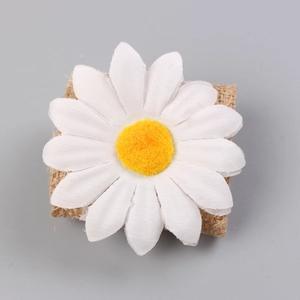 Detail view of rustic sunflower napkin ring featuring a white daisy and burlap rope base