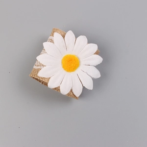 Detailed view of daisy napkin ring featuring burlap texture and white lace trim