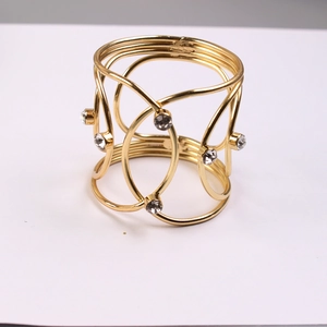 Detail of gold metal mesh napkin ring featuring intricate woven wire and sparkling rhinestones
