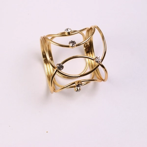 Elegant gold metal napkin ring with sparkling diamond rhinestones and woven cross design