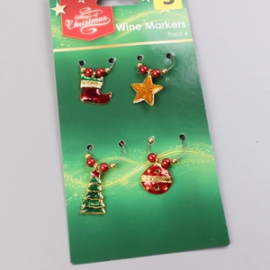 Detail of 4-pack Christmas wine glass markers with tree and star charms on green card